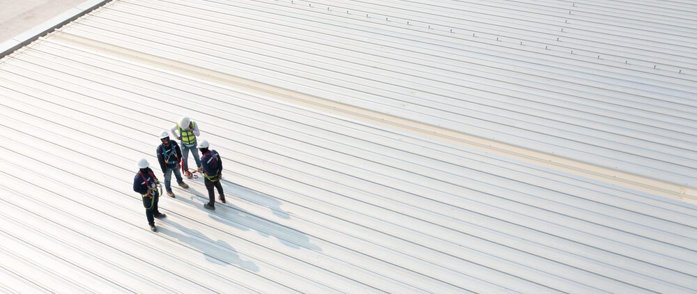 arial view of four commercial roofers