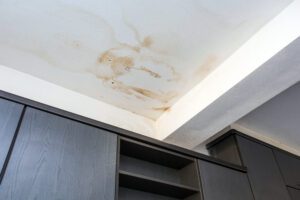 Water stains on a ceiling indicate a water leak.