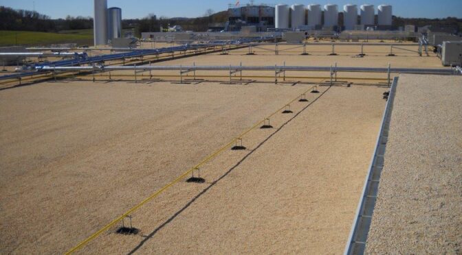 A commercial flat roof with built-up roofing material.