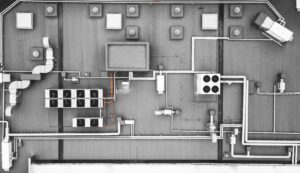 Top view of an AC unit and vents on a commercial building