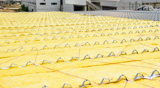 Yellow insulation on a commercial roof before the roofing material is installed.