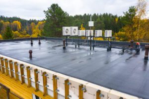 A commercial roof with black roofing materials on it.