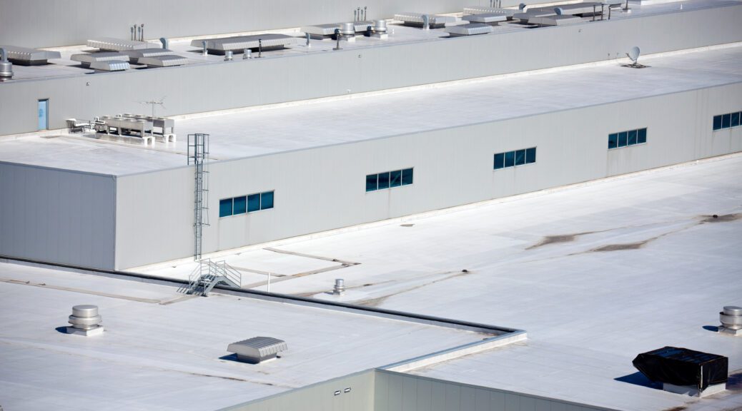 The white roof of a manufacturing facility