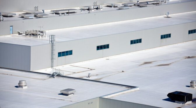 The white roof of a manufacturing facility