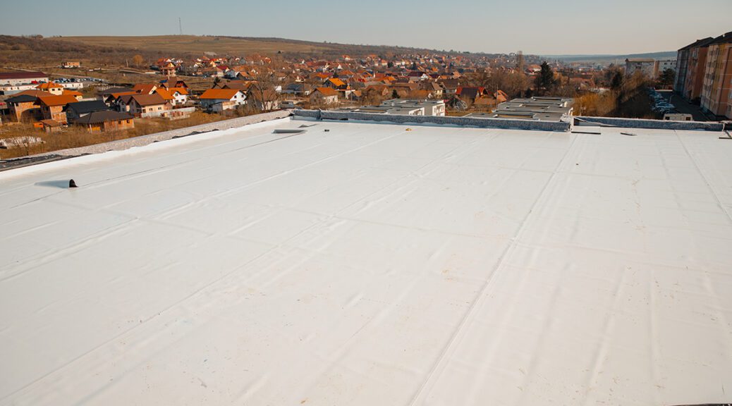 A flat roof with a white reflective PVC membrane.