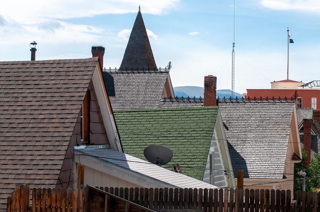 Steep roofs of varying degrees with blue sky in the background.
