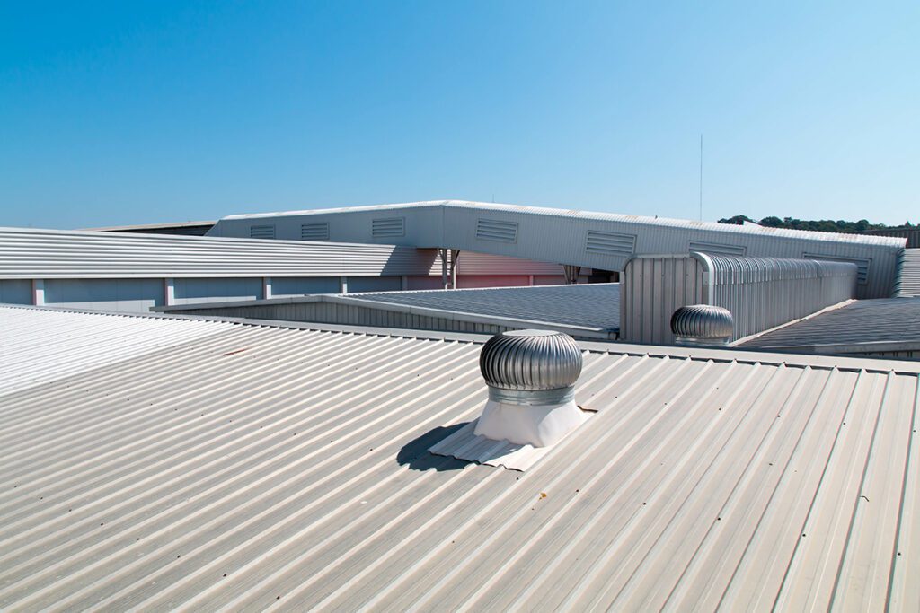 A metal roof with a vent on top.