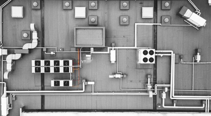 A top-down view of an industrial roof, including the HVAC and venting systems