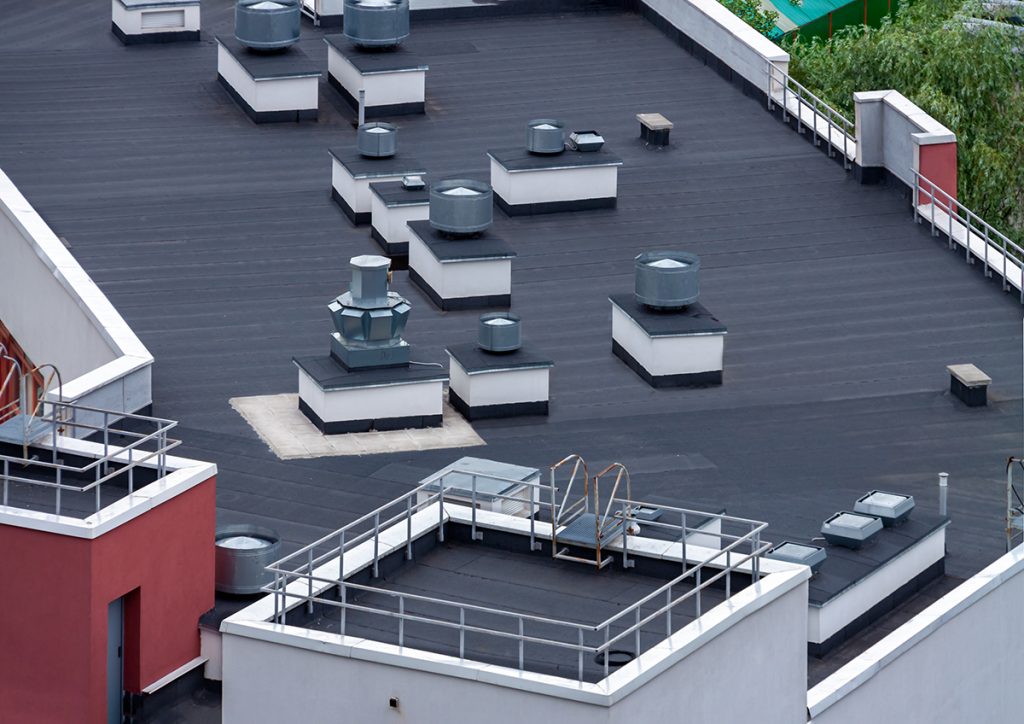 The roof of an apartment building with a built-up roofing system