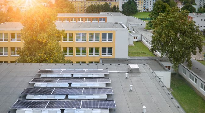 A commercial flat roof with solar panels on it